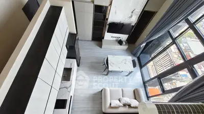 Modern high-rise apartment with floor-to-ceiling windows and stylish interior design.