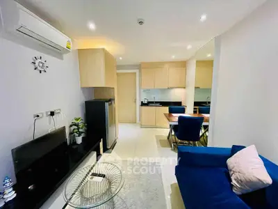 Modern living room with blue sofa and dining area in stylish apartment