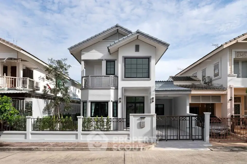 Charming two-story house with modern facade and spacious driveway in suburban neighborhood.