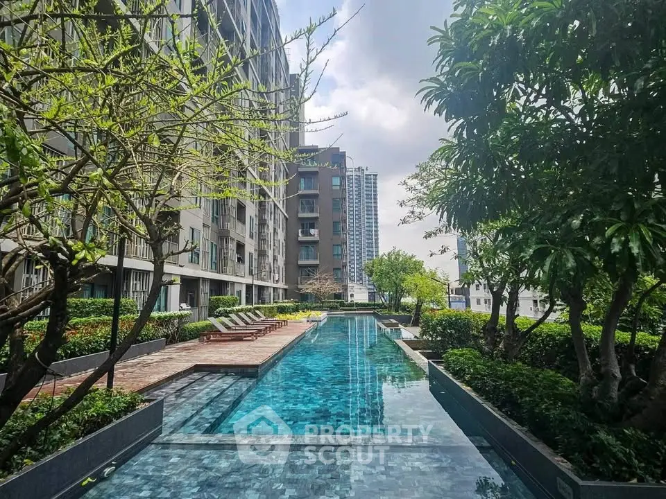 Luxurious apartment complex with stunning outdoor pool and lush greenery, perfect for relaxation and leisure.