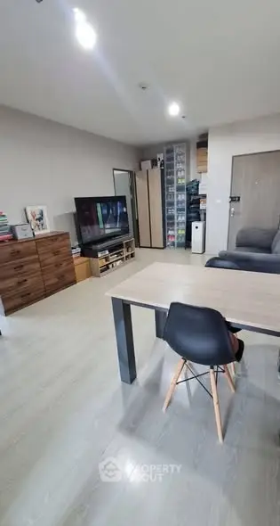 Spacious modern living room with sleek furniture and ample storage space.