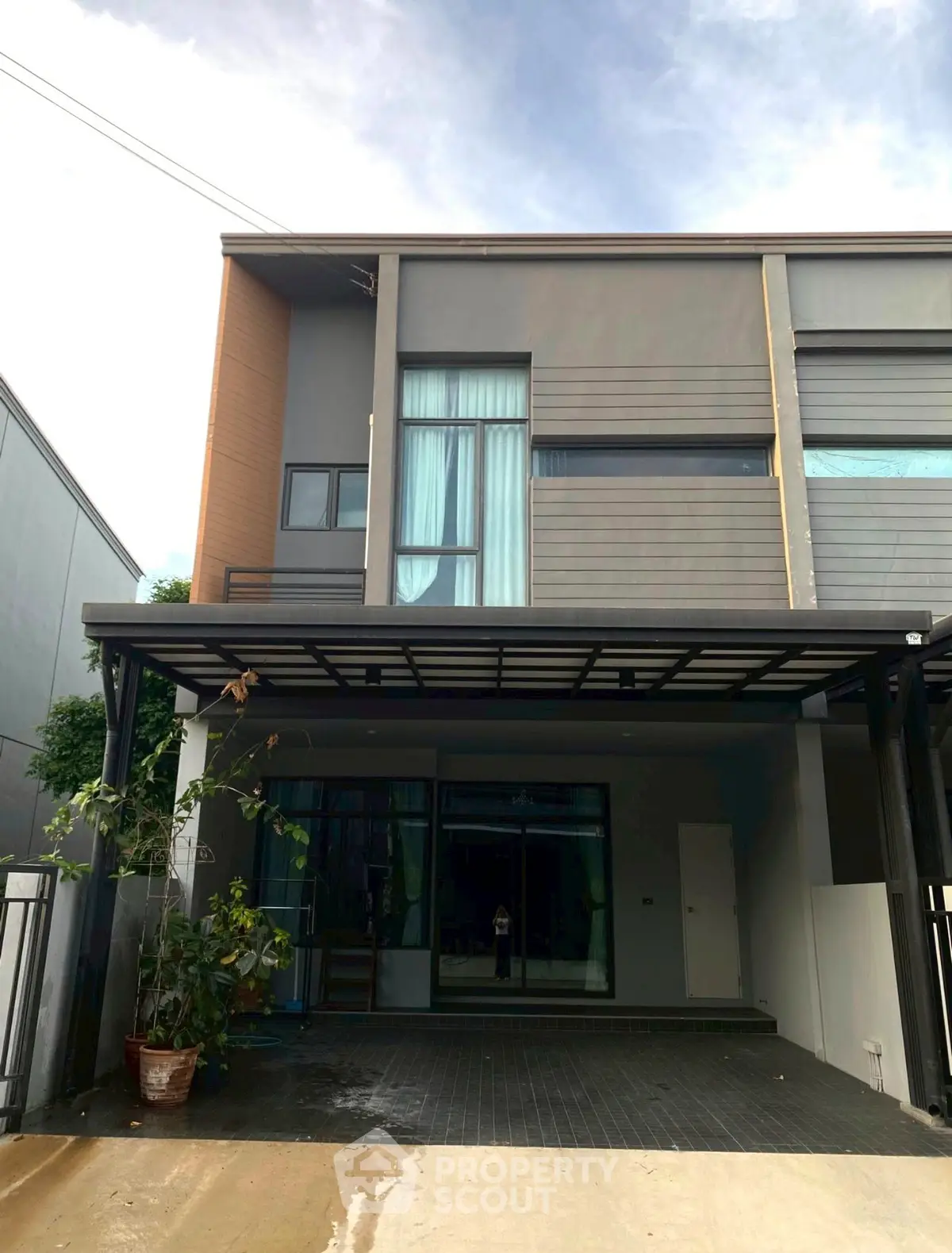 Modern two-story house with sleek facade and large windows