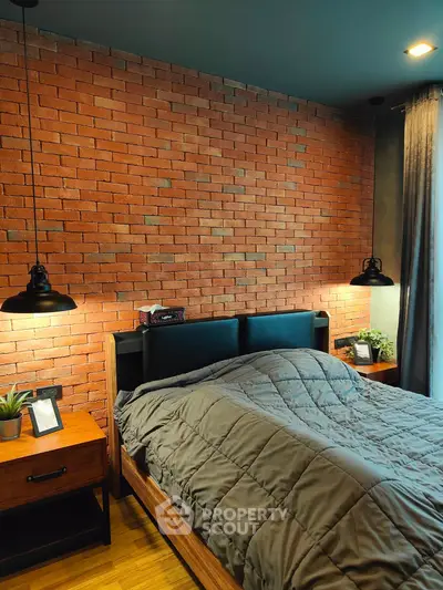 Cozy bedroom with exposed brick wall and modern lighting