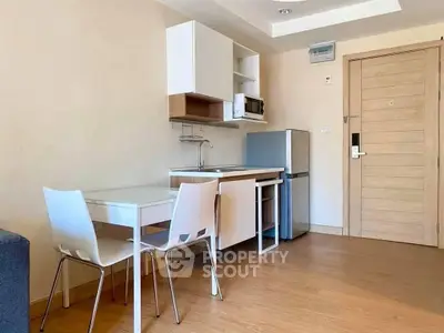 Modern compact kitchen with dining area in cozy apartment