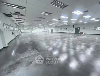 Spacious industrial warehouse with polished concrete floors and ample lighting.