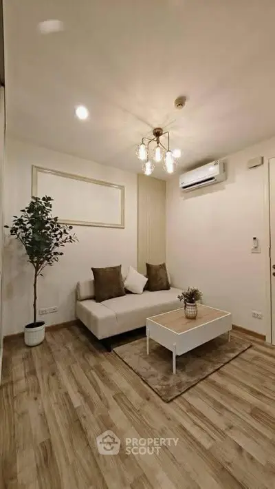 Stylish modern living room with cozy sofa, chic lighting, and elegant wooden flooring.