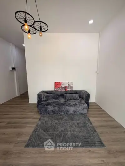 Modern living room with stylish lighting and cozy sofa, perfect for relaxation.