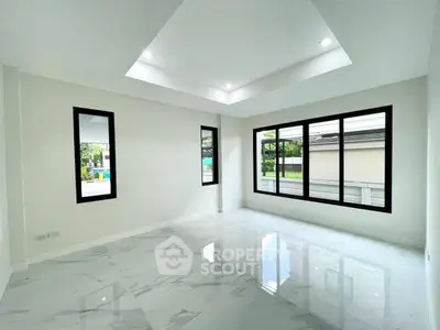 Spacious modern living room with large windows and marble flooring