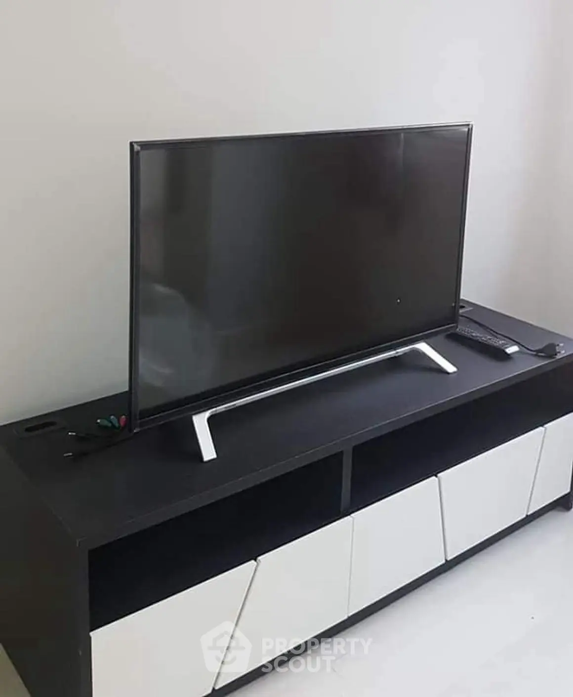 Modern living room with sleek TV stand and flat-screen television