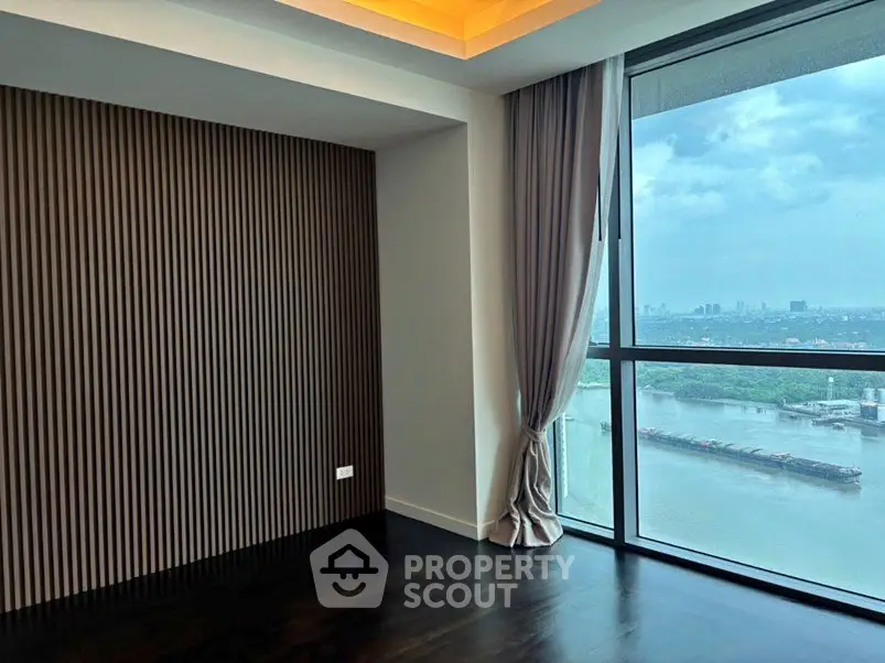 Luxurious corner unit with stunning river view and floor-to-ceiling windows.