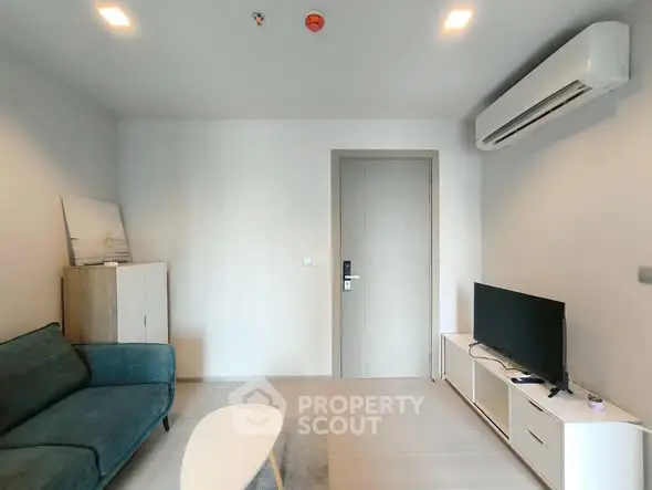 Modern living room with sleek furniture and air conditioning unit