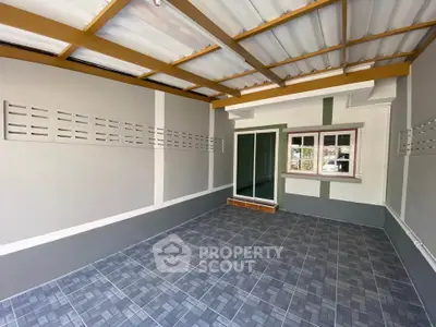 Spacious covered patio with tiled flooring and modern design