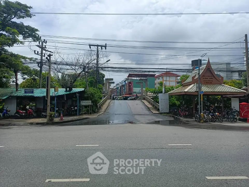 Charming urban street view with traditional architecture and lush greenery.