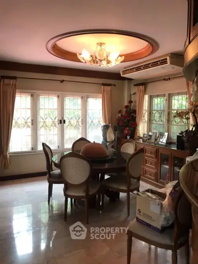 Elegant dining room with chandelier and classic furniture, perfect for family gatherings.