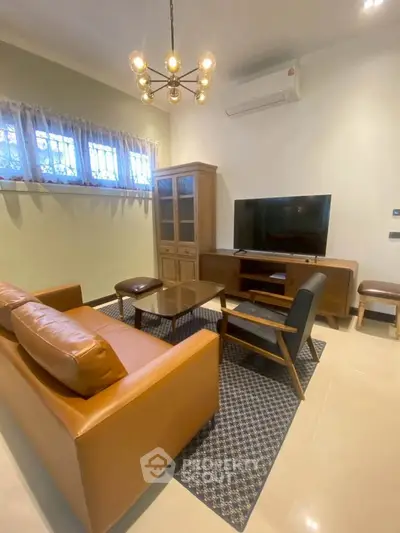 Stylish living room with modern furniture and elegant lighting, perfect for relaxation and entertainment.