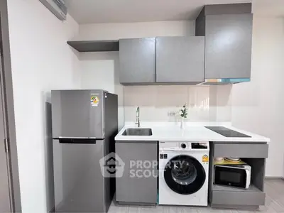 Modern compact kitchen with washing machine and fridge in sleek design
