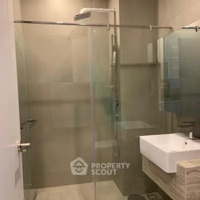 Modern bathroom with glass shower enclosure and sleek sink design