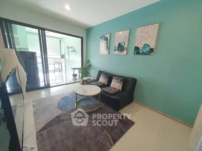 Modern living room with stylish decor and balcony access in a contemporary apartment.