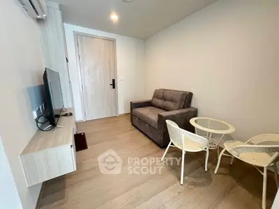 Modern living room with cozy sofa and stylish furniture in a compact space.