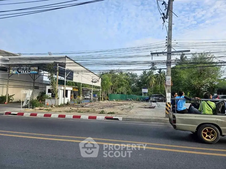 Vacant land plot with potential for development on a busy street corner.