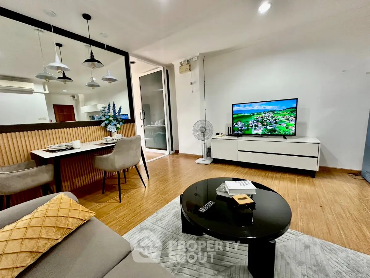 Modern living room with stylish decor, open layout, and elegant dining area, perfect for contemporary living.