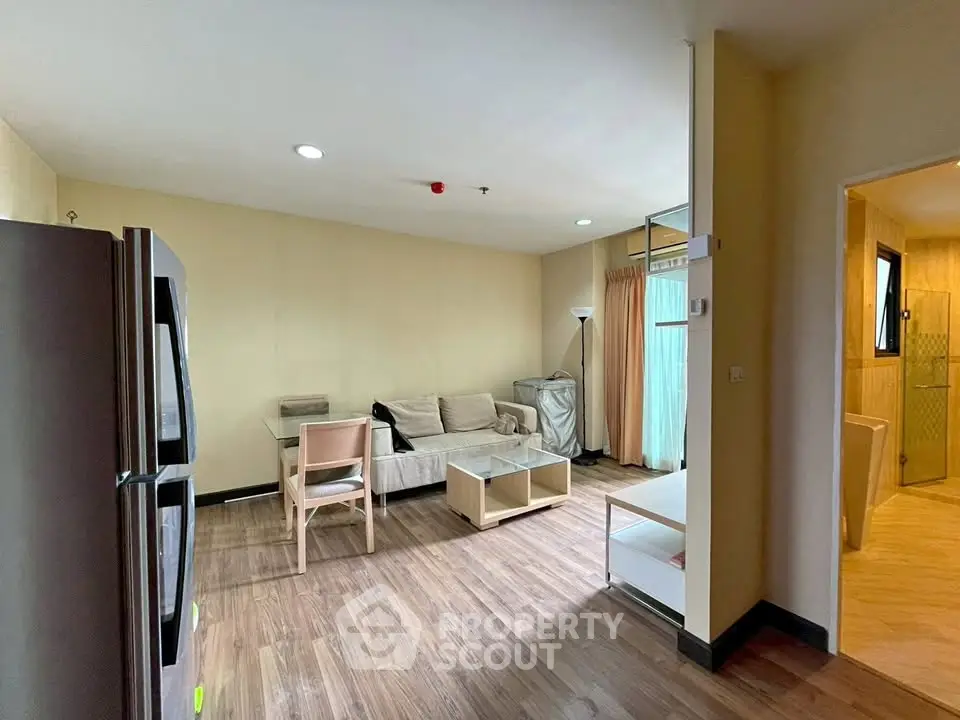Spacious living room with modern decor and open layout in a stylish apartment.