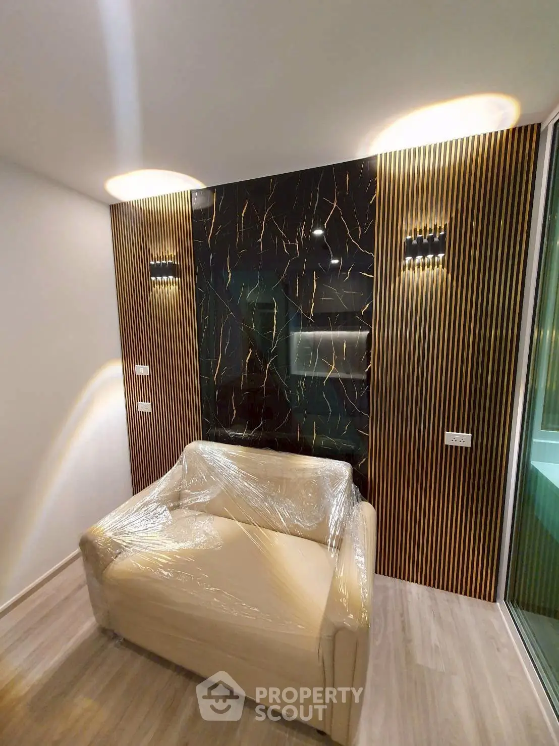 Modern living room with stylish accent wall and cozy armchair