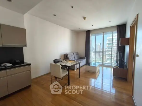 Modern open-plan living room with city view and sleek kitchen area