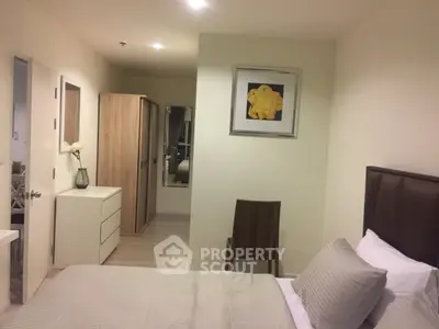 Modern bedroom with stylish decor and ample storage in a cozy apartment.