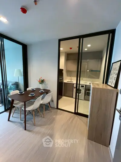 Modern dining area with sleek kitchen and stylish decor