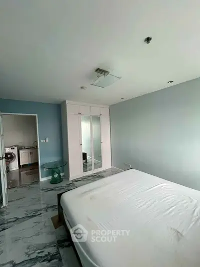 Spacious bedroom with modern design and marble flooring