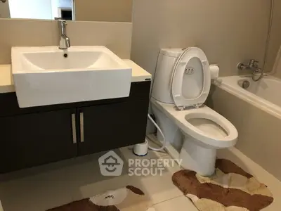 Modern bathroom with sleek fixtures and bathtub in a contemporary home.