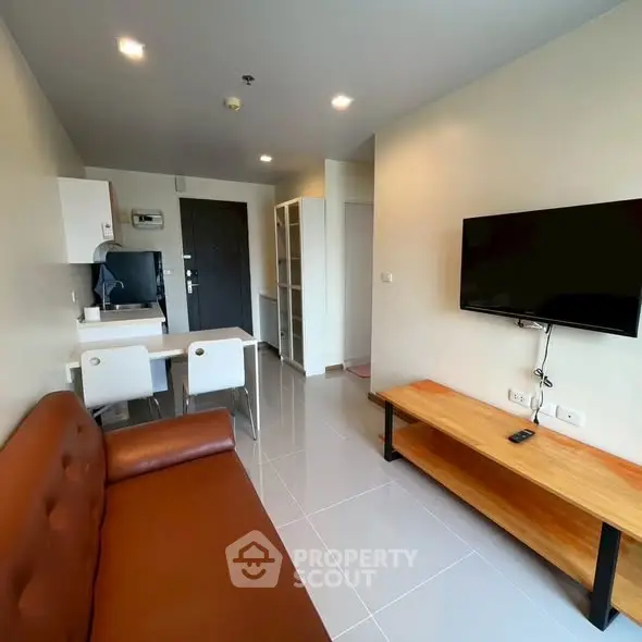 Modern living room with sleek furniture and wall-mounted TV in a stylish apartment.