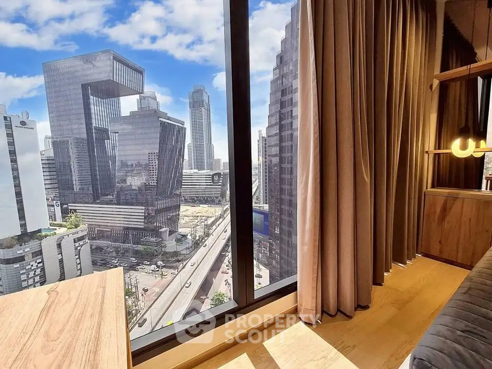 Stunning cityscape view from modern high-rise apartment window with sleek wooden interior design.