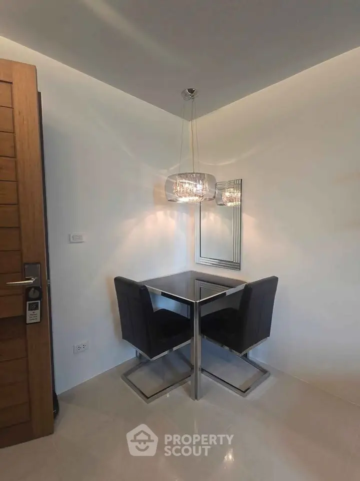 Modern corner dining area with sleek chairs and stylish lighting