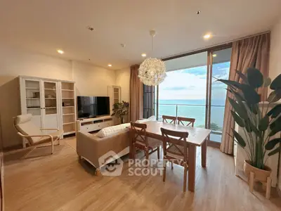 Stunning living room with ocean view, elegant furniture, and large windows for natural light.
