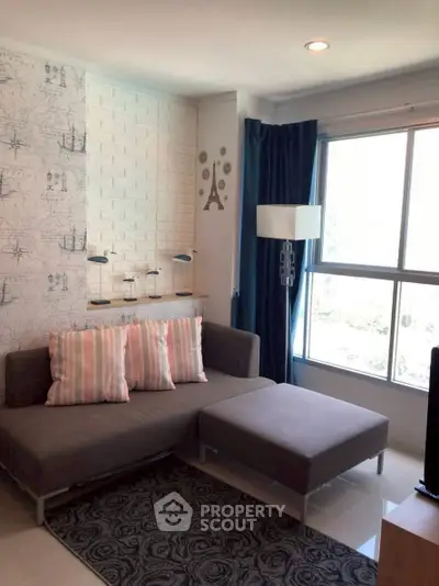 Modern living room with stylish decor and large window for natural light.