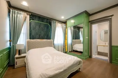 Luxurious bedroom with elegant green accents and mirrored wardrobe