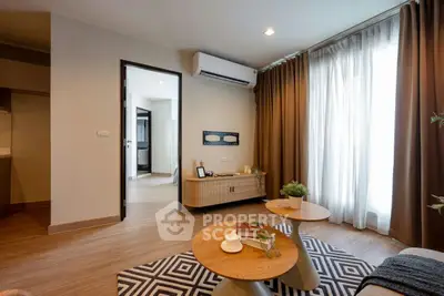 Modern living room with stylish furniture and natural light, featuring a cozy ambiance and contemporary design.