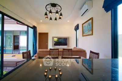 Modern living room with stylish lighting and open layout, featuring a cozy sofa and elegant decor.