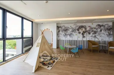 Spacious modern living room with play area and large windows