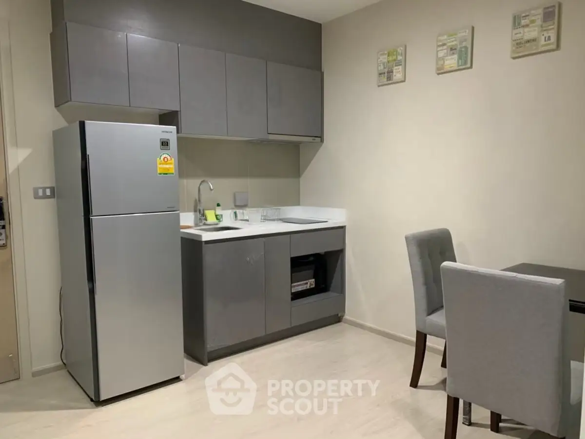 Modern kitchen with sleek cabinets and dining area in a stylish apartment
