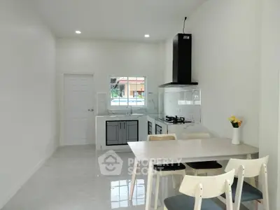 Modern kitchen with dining area and gas stove in bright open layout
