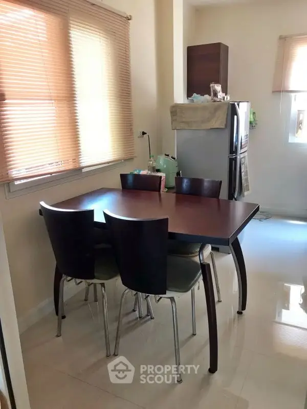 Cozy kitchen with dining table and modern appliances, perfect for family meals.