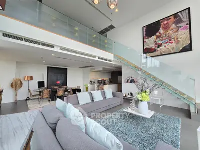 Luxurious modern living room with high ceilings and stylish decor in a spacious open-plan layout.
