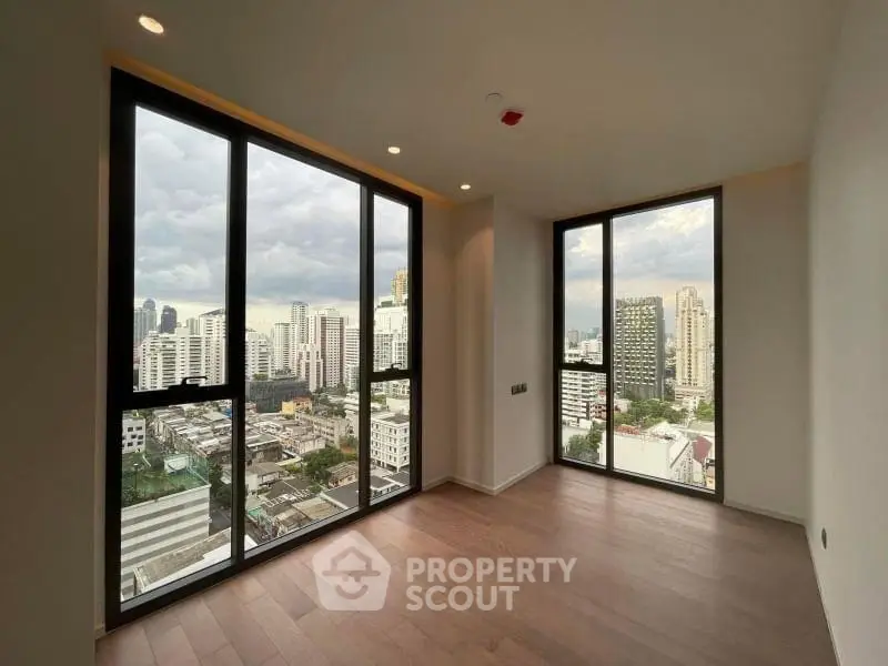 Spacious corner unit with stunning city views through large windows, perfect for urban living.