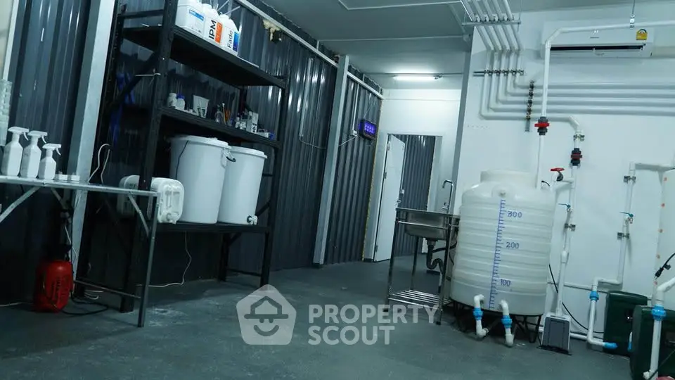 Industrial-style storage room with metal shelves and large water tanks.