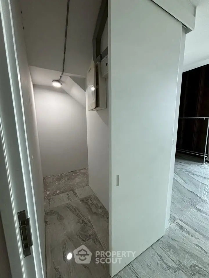 Compact storage space with sliding door and modern flooring