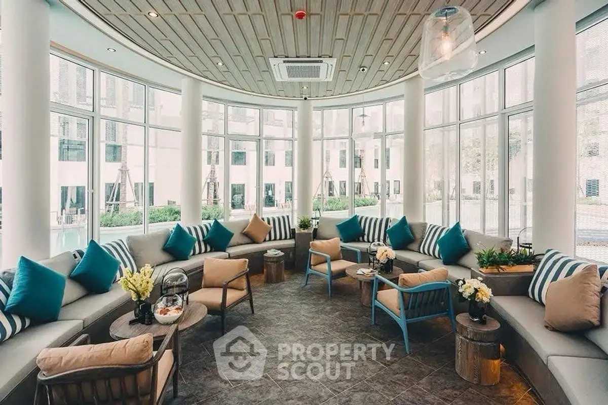 Luxurious curved living room with panoramic windows and stylish decor