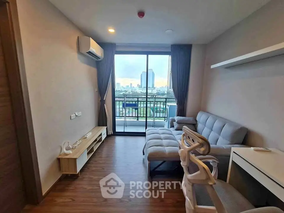 Modern living room with city view and balcony access, featuring sleek furniture and stylish decor.